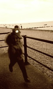 Boy running near a beach in sepia